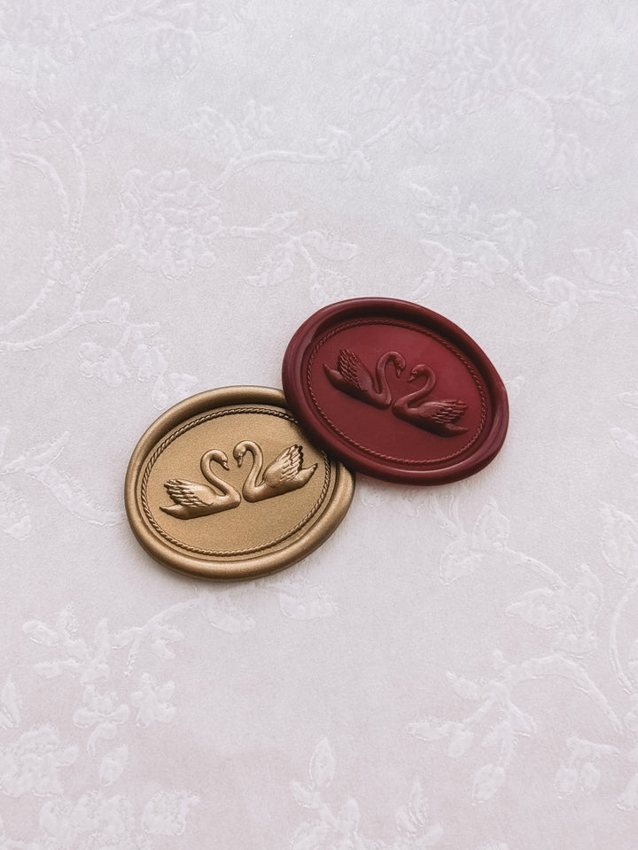 Gold and burgundy colored dark red double swan oval wax seals