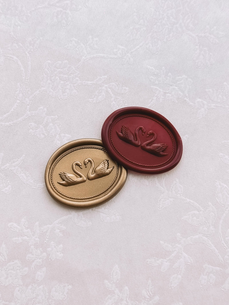 Gold and burgundy colored dark red double swan oval wax seals