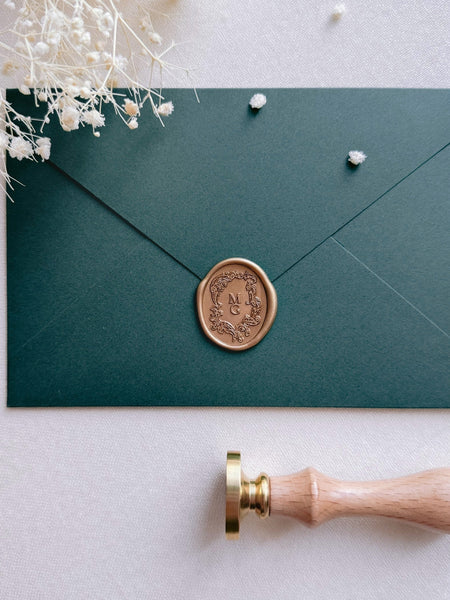 custom monogram vintage crest oval gold wax seal on dark green envelope 