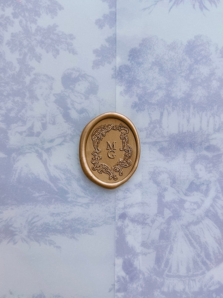 gold vintage crest custom monogram wax seal on a blue vintage print vellum jacket