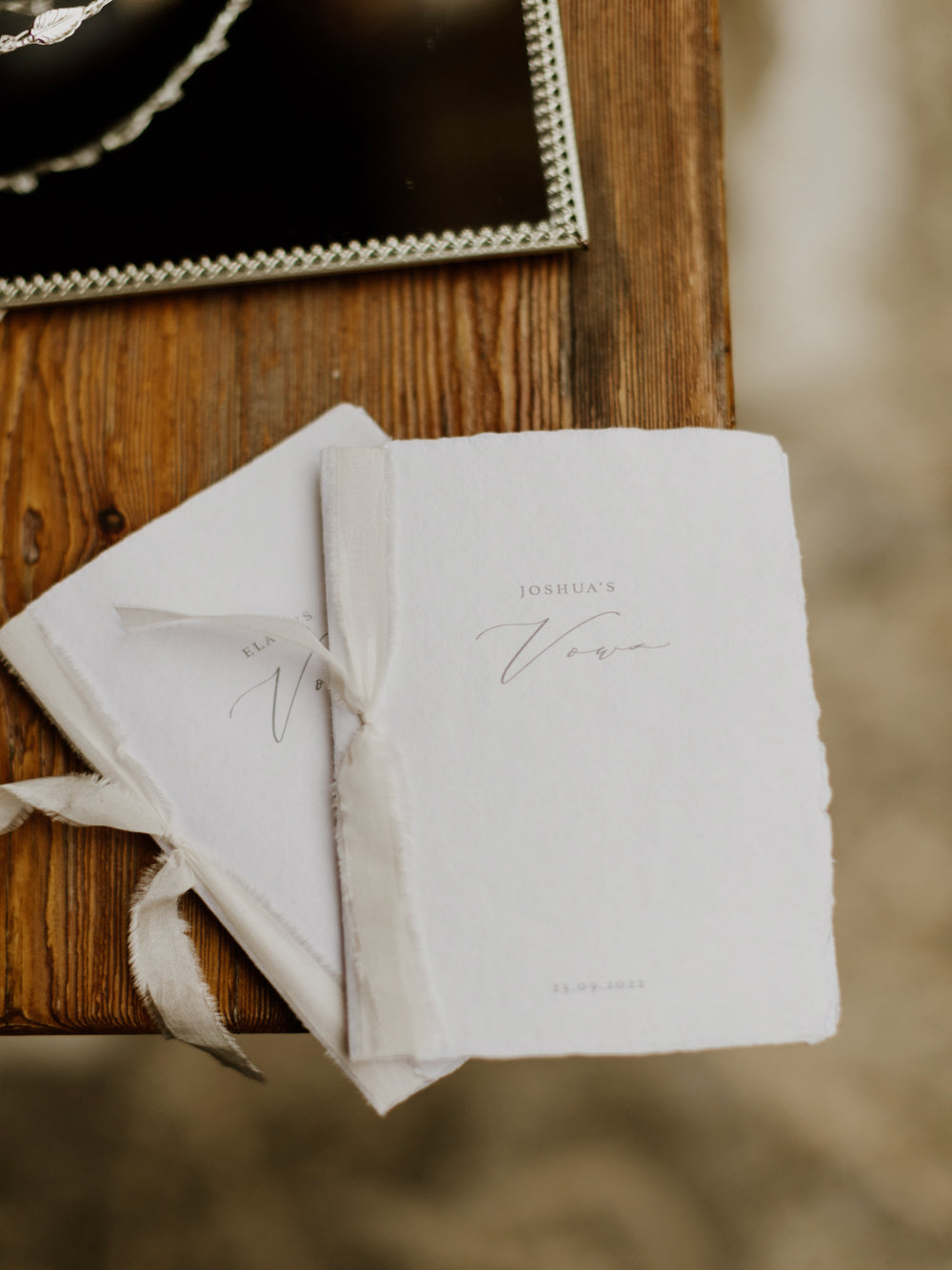personalized white handmade paper wedding vow books with champagne colored silk ribbons 