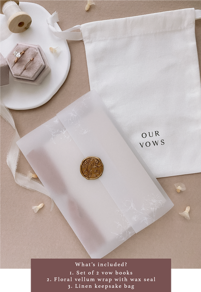 Vow books packaged in a vellum jacket and gold wax seal next to a white linen keepsake pouch with OUR VOWS printed on it