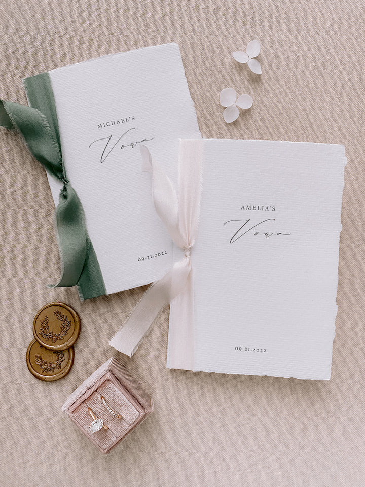 personalized white handmade paper vow books with green and pink silk ribbons