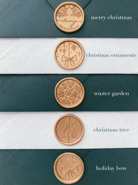 Christmas Wax Seals shown in Merry Christmas, Christmas Ornament, Winter Garden, Christmas Tree and Holiday box in gold on handmade paper envelopes