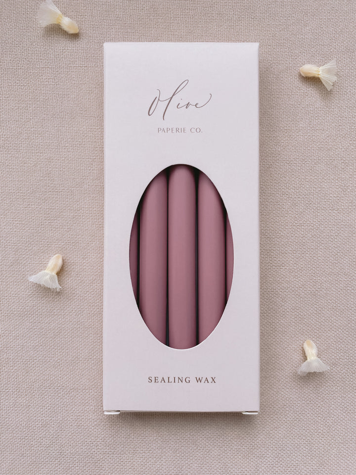 a box of 5 glue gun sealing wax sticks in rosewood color styled with dried flower petals