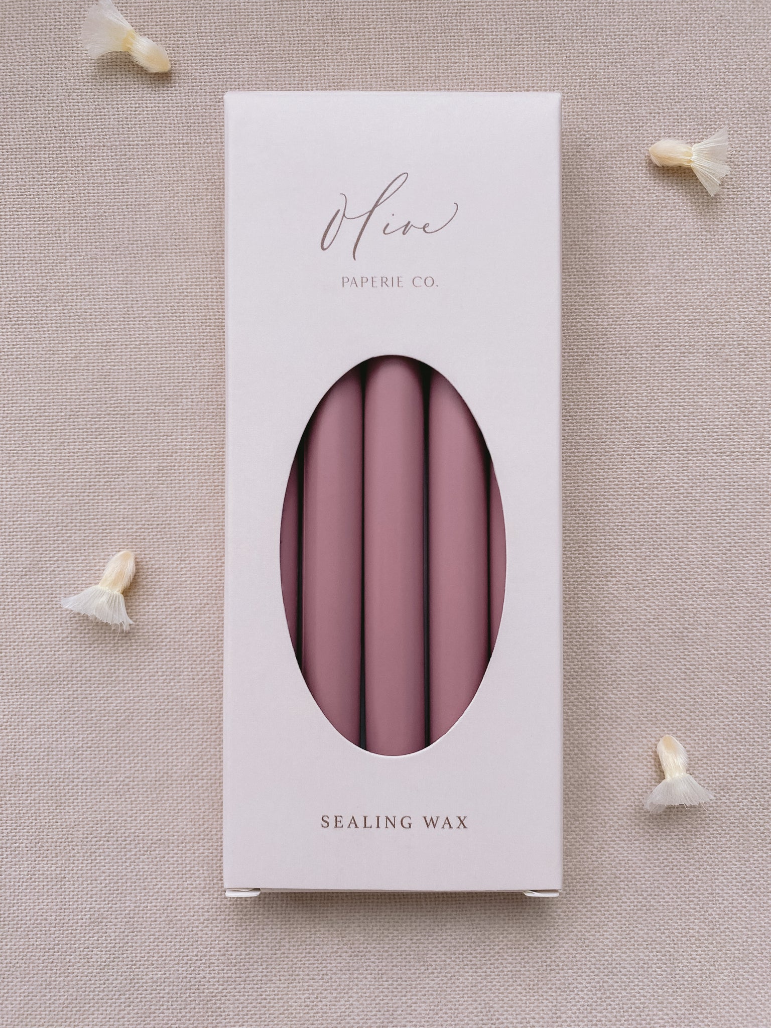 a box of 5 glue gun sealing wax sticks in rosewood color styled with dried flower petals