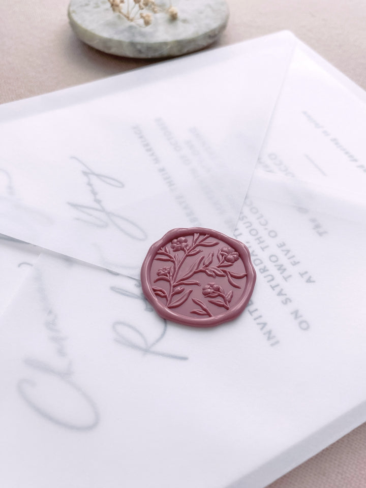 Dusty rose colored floral wax seal on vellum wedding invitation envelope 