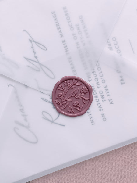 Floral pattern wax seal in rosewood color on vellum envelope with wedding invitation insert