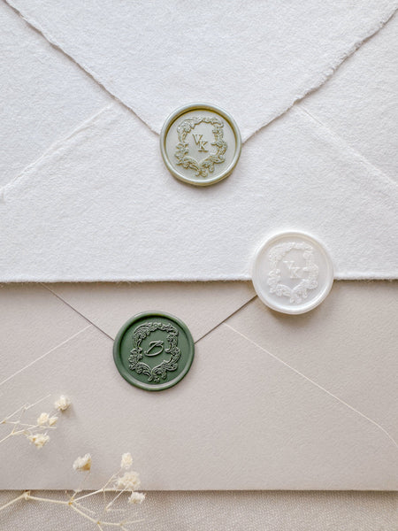 Vintage crest monogram wax seals in light metallic green, pearl white, and sage green