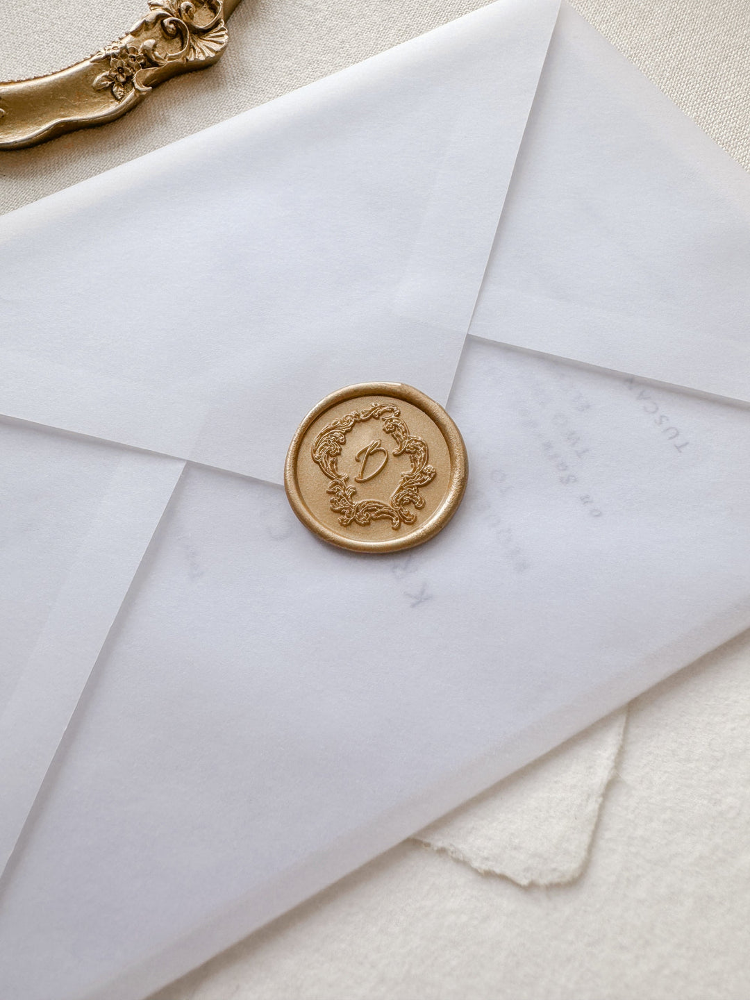 light gold vintage crest custom wax seal on  vellum envelope