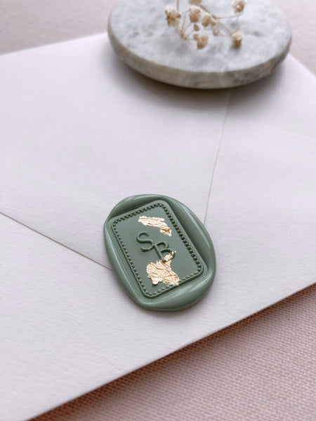 Dotted border rectangular monogram wax seal in sage green on white envelope
