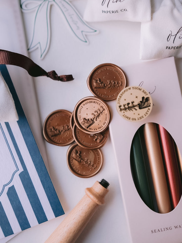 Antique bronze Santa sleigh Christmas wax seals styled with festive sealing wax sticks, Christmas cards and gift tags