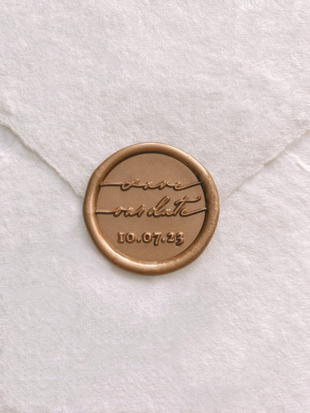 Gold wax seal with "Save our date" and personalized date