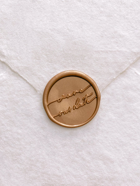 Gold save our date calligraphy script wax seal on beige handmade paper envelope