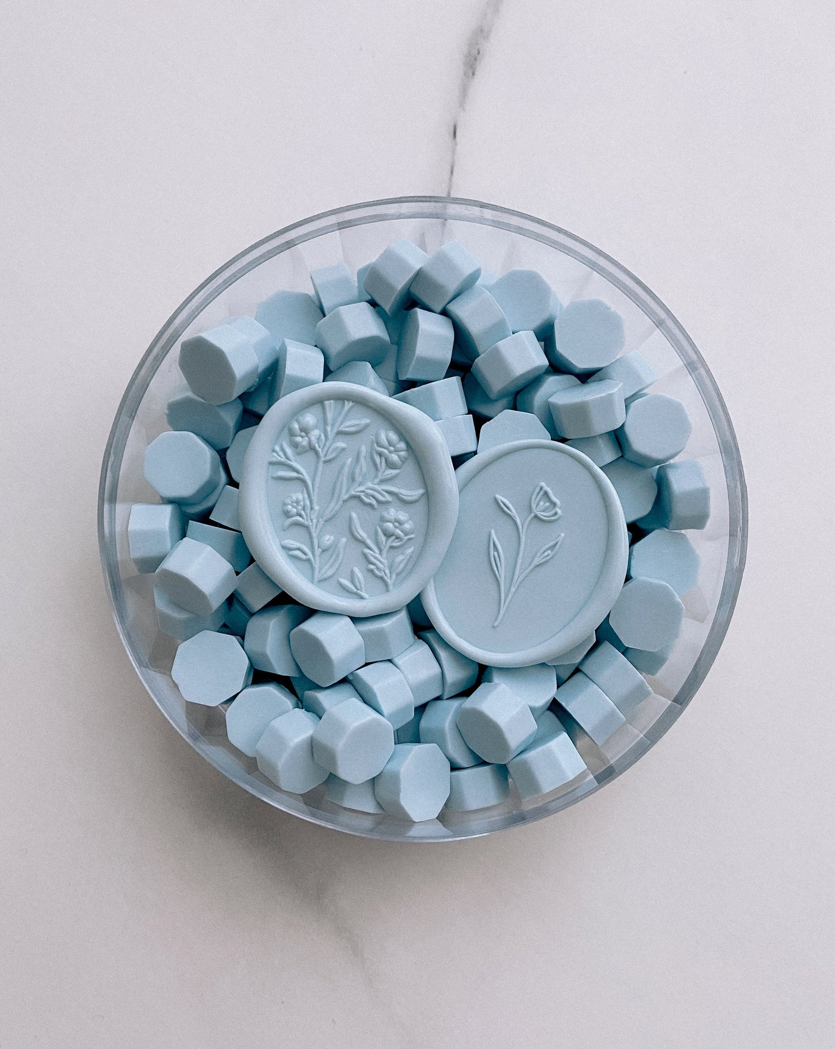 a box of sky blue sealing wax beads with scarlette 3d floral wax seal and simple flower wax seal in sky blue color