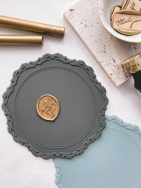 Silicone mat in charcoal and pale blue with gold wax seal_closeup