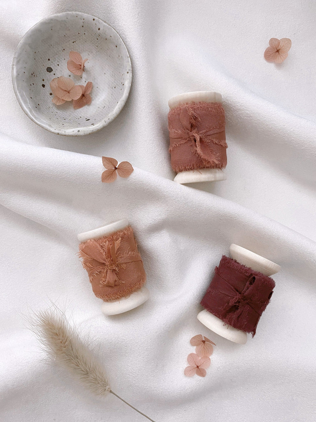 1 inch raw edge silk ribbon on wooden spools in color Clay, Terracotta, and Wine