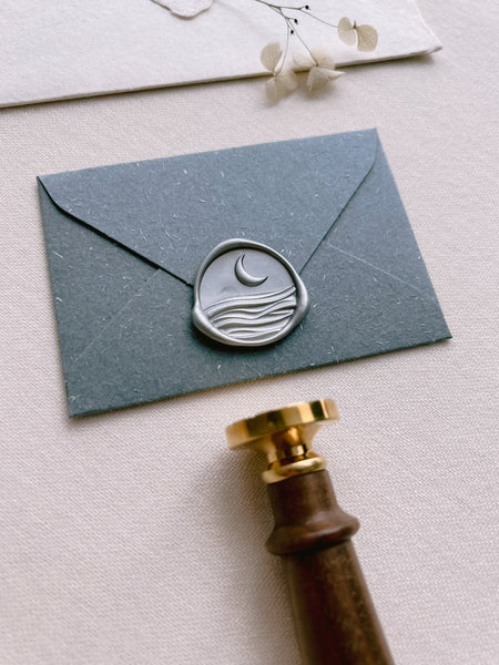 moon and ocean waves silver wax seal on a mini envelope 