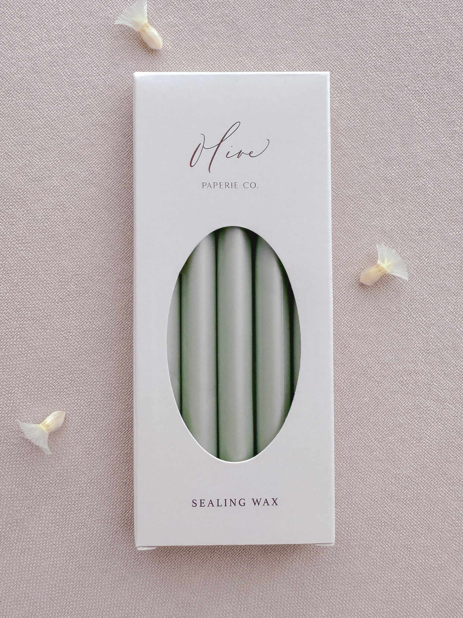 Light metallic sage green sealing wax sticks in a box
