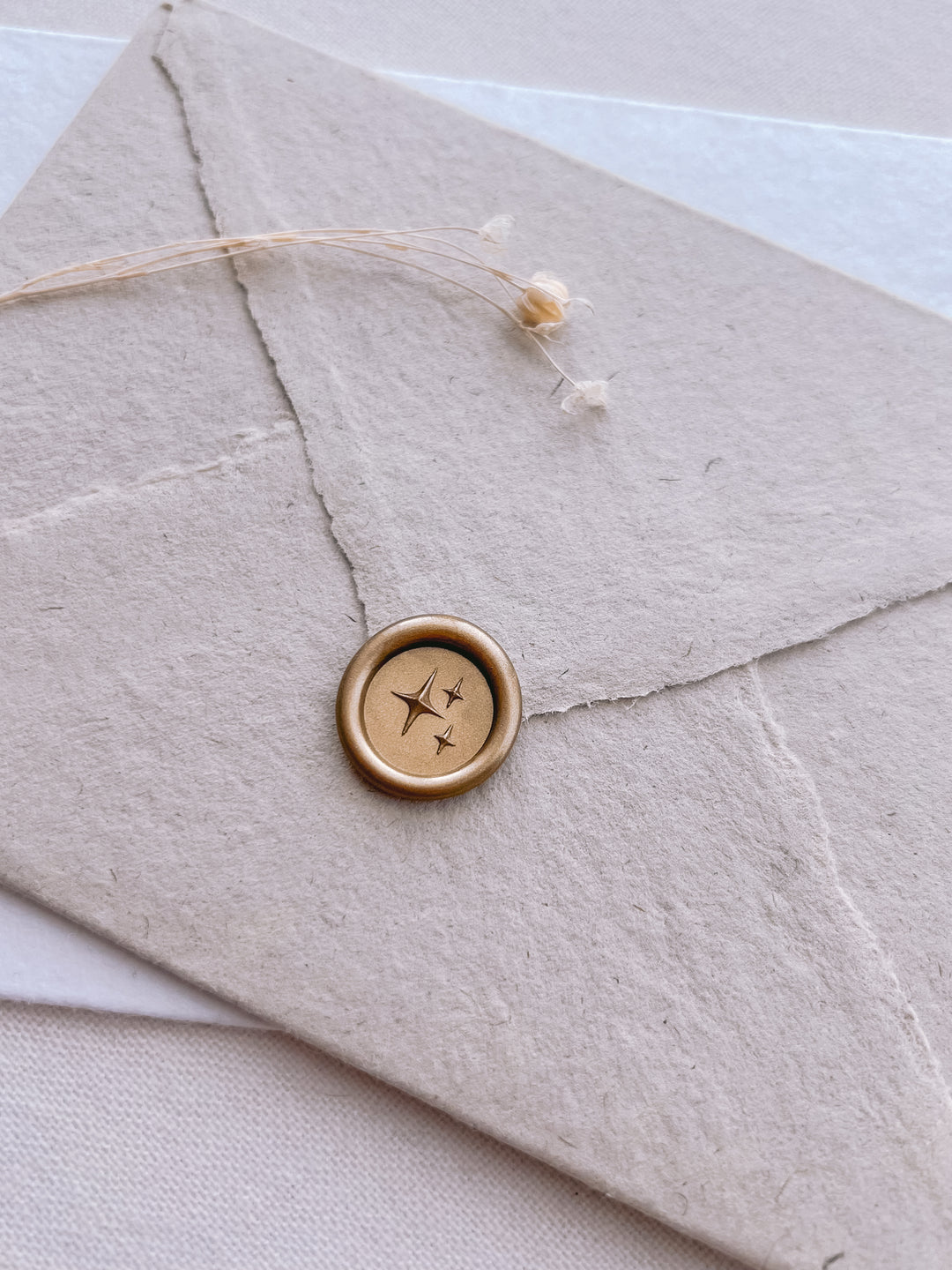 gold 3D stars mini wax seal on a beige envelope 