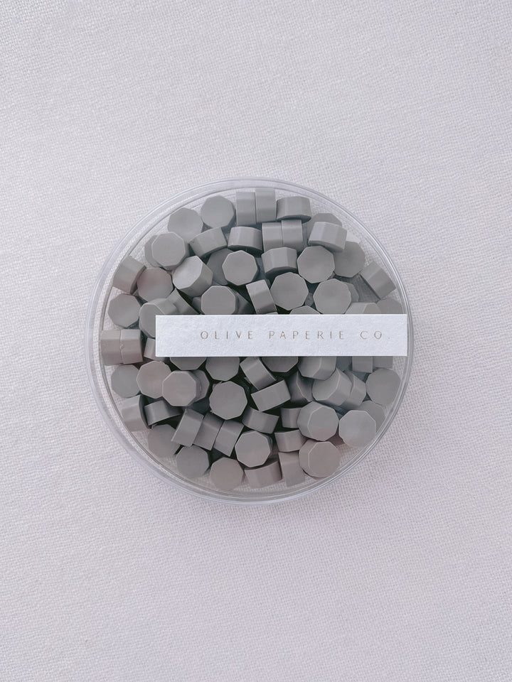 taupe colored sealing wax beads in a clear container box