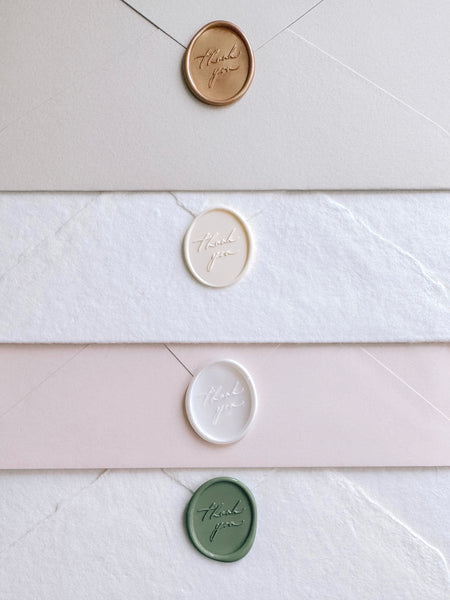 Oval wax seals featuring "thank you" in calligraphy script, in colors peachy gold, antique white, soft white and sage green