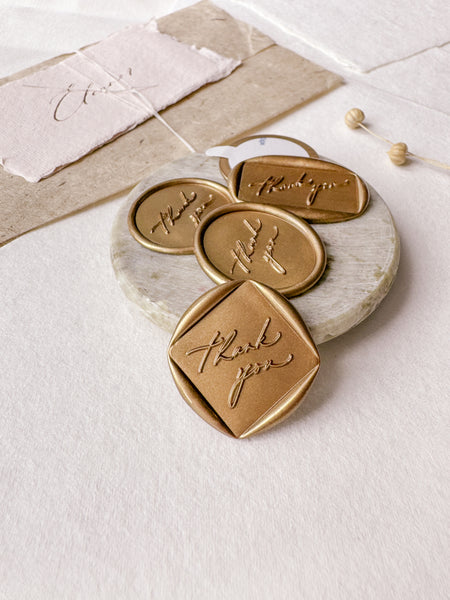 Calligraphy script "thank you" wax seals in gold and in various shapes 