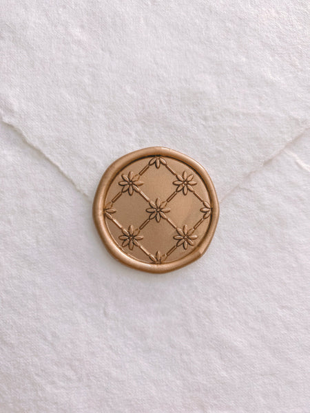 Daisy Wax Seal in light gold on handmade paper envelope
