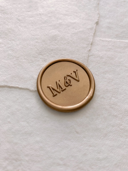 Typeface monogram round wax seal in gold on handmade paper envelope_side angle