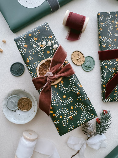 Festive gift wrap decorated with rust colored velvet ribbon 