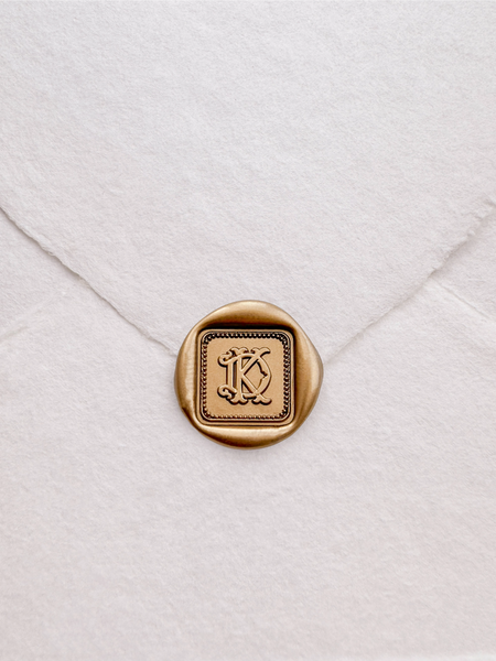 Gold square border vintage interlocked monogram wax seal featuring personalized initials on a white envelope