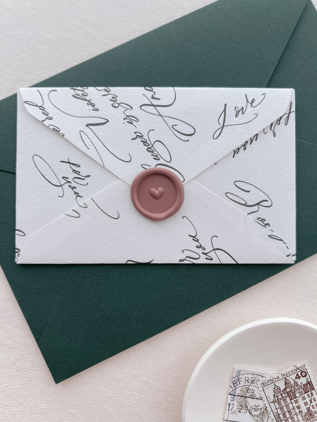 dusty rose colored 3D heart design mini wax seal on a white envelope