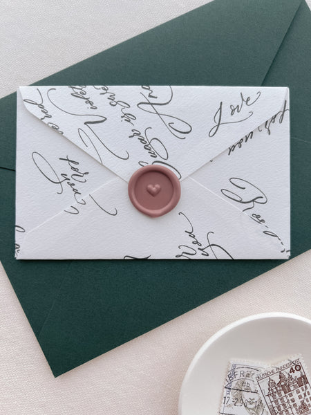 dusty rose colored 3D heart design mini wax seal on a white envelope