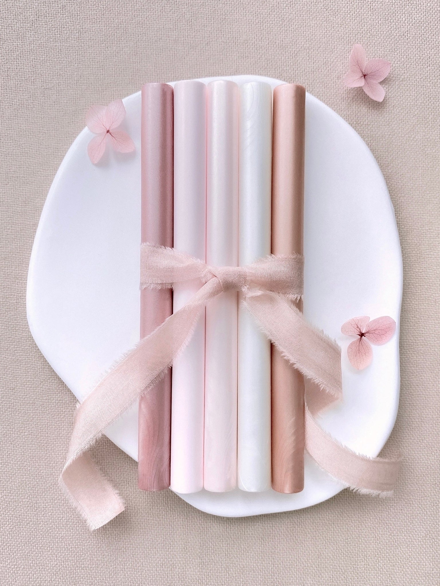 a set of 5 blush tones sealing wax sticks in rose gold, light blush, nude pearl, white pearl, coral colors_front angle