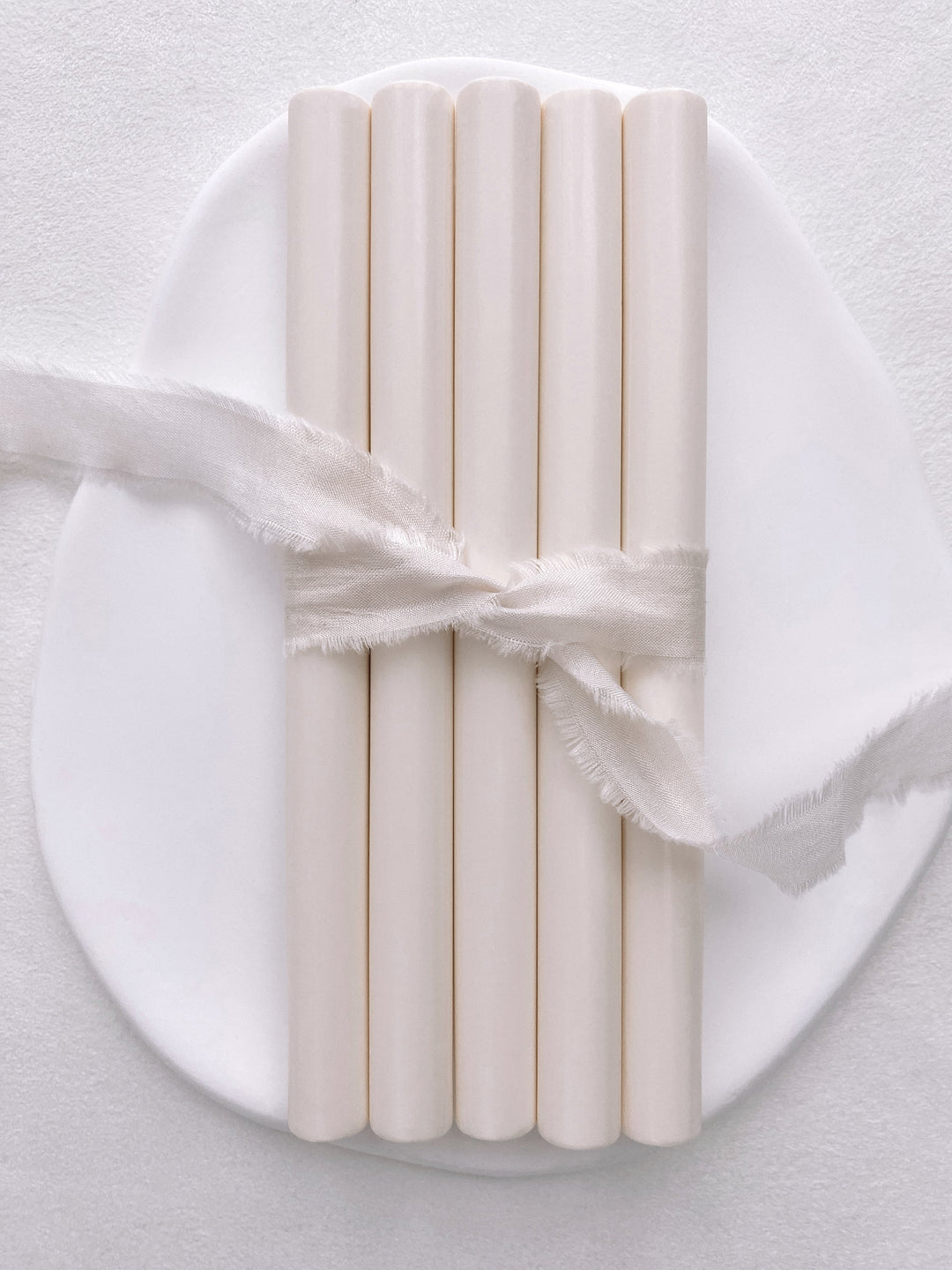 A set of 5 off-white glue gun sealing wax sticks tied with soft white silk ribbon 