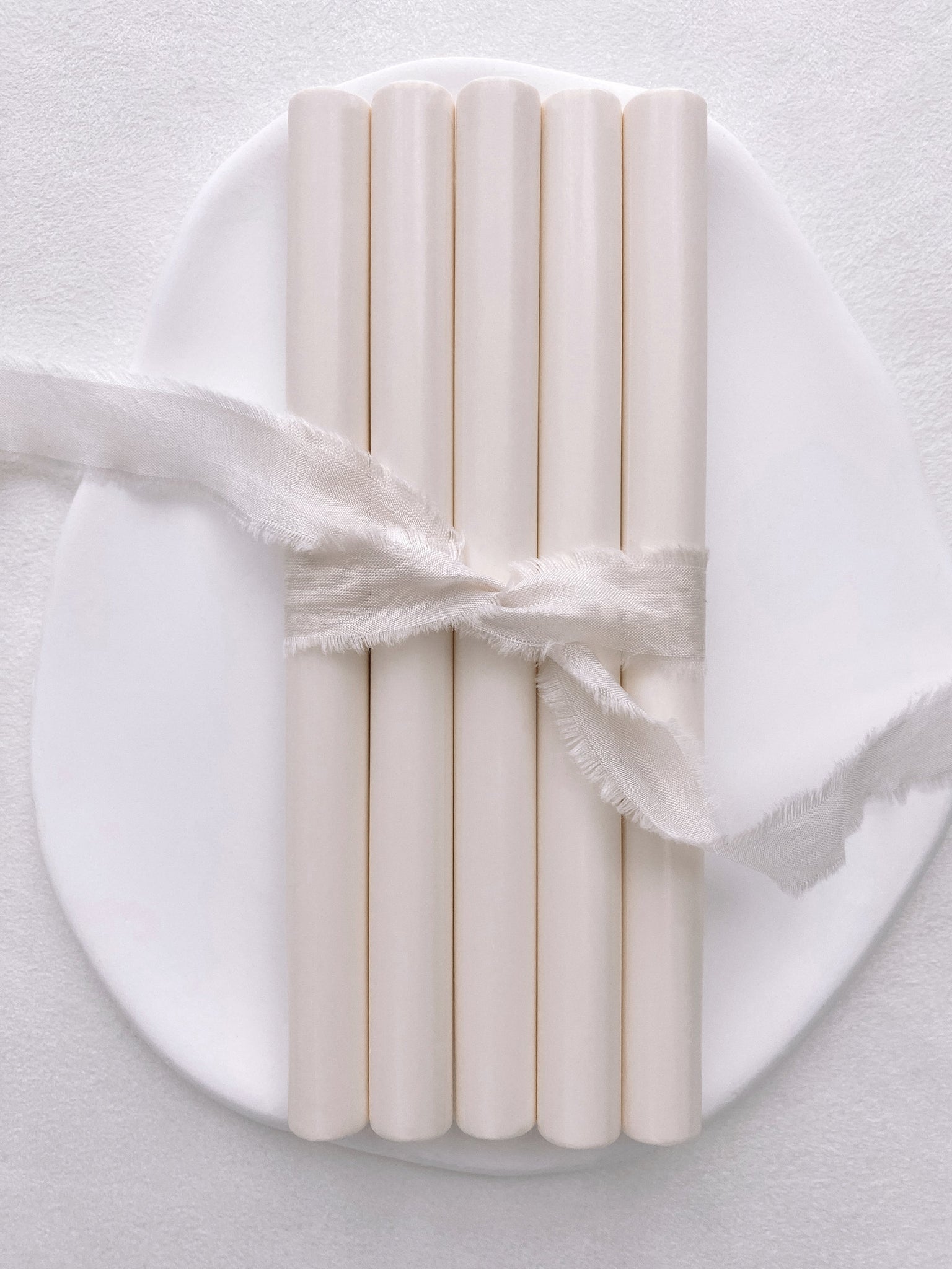 A set of 5 off white sealing wax sticks