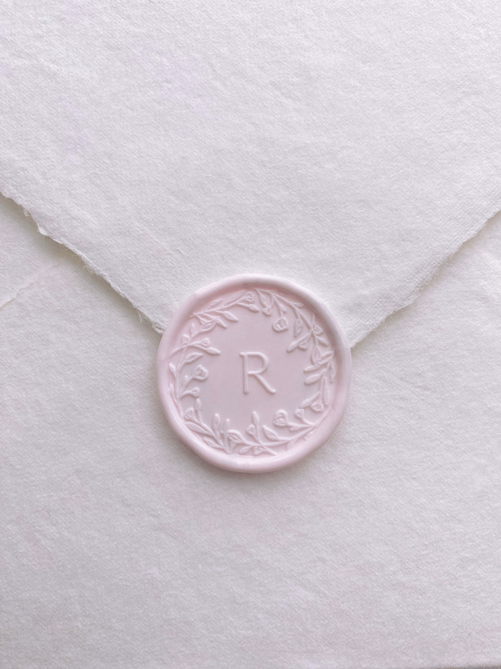Floral crown single initial wax seal in light blush color on handmade paper envelope
