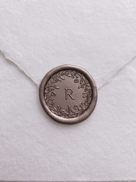 Floral crown single initial wax seal in mocha on handmade paper envelope_front angle