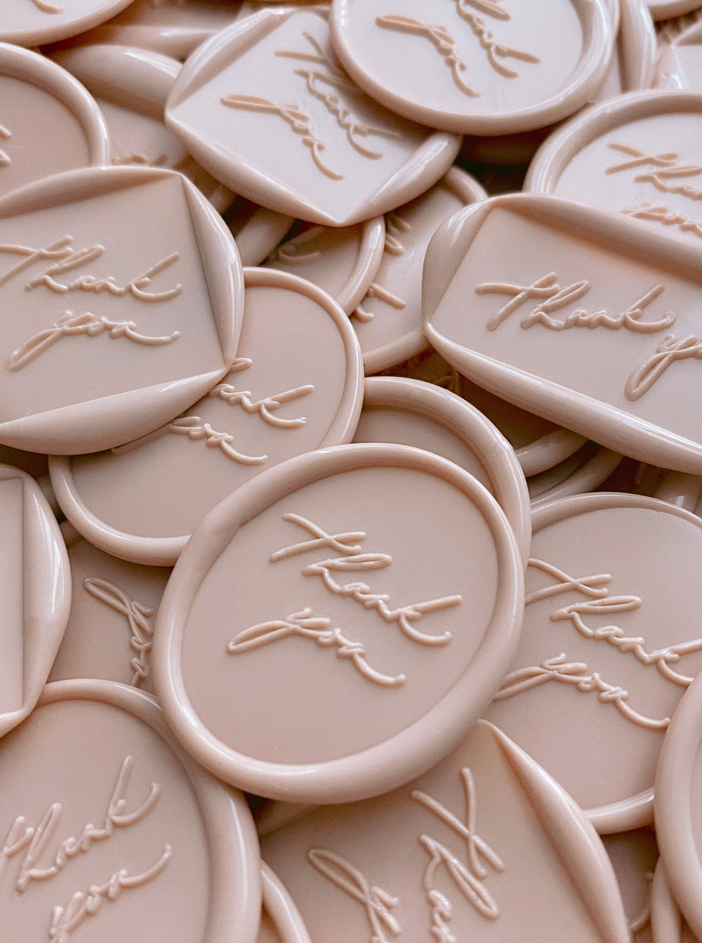 a bundle of thank you wax seals in shapes of round, rectangular, diamond and oval in nude color