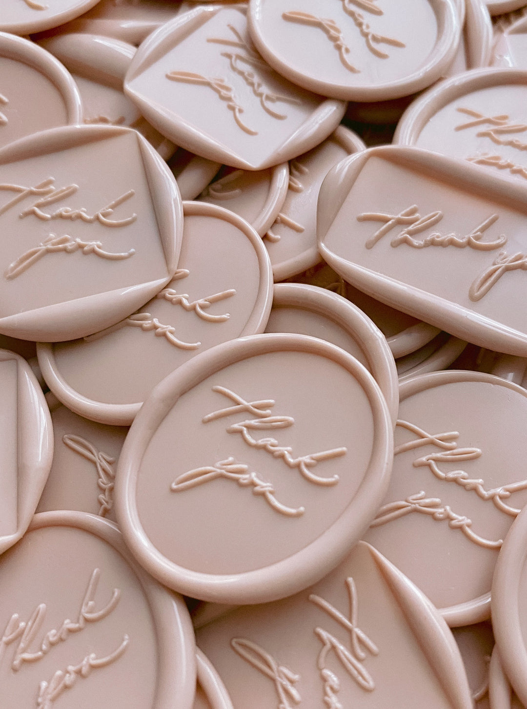 a bundle of thank you wax seals in shapes of round, rectangular, diamond and oval in nude color
