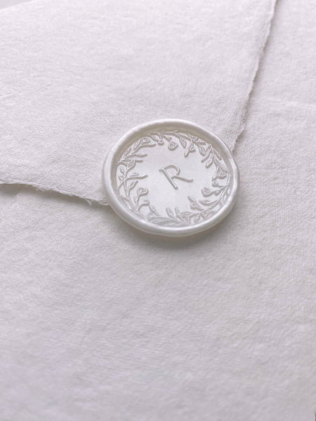 Floral crown single initial wax seal in white pearl on handmade paper envelope_side angle