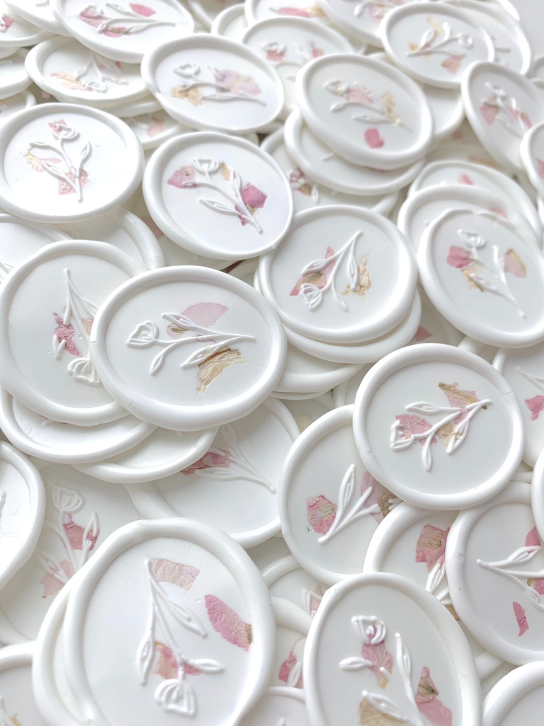 a bundle of white oval wax seal sticker with blush color dried petals
