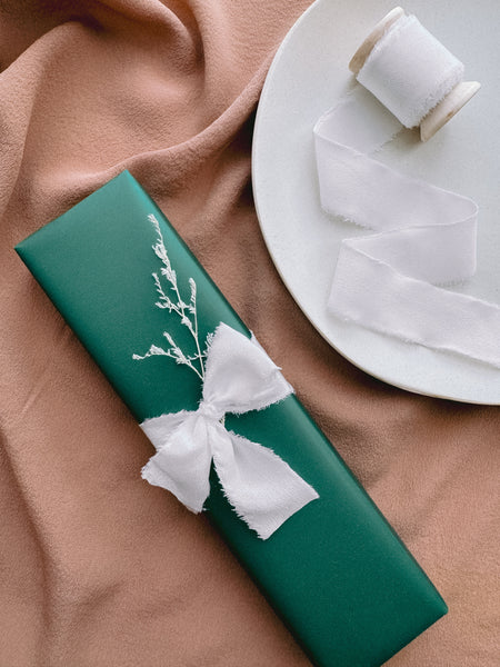 Christmas gift decorated with white frayed edge silk ribbon