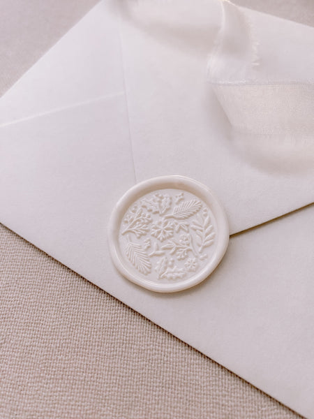 Winter garden wax seals in off-white on white paper envelope styled with white silk ribbon